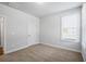 Neutral bedroom featuring carpet flooring and a window at 3293 Lions Ruby Ln, Atlanta, GA 30349