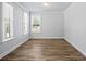 Bright bedroom with hardwood floors and natural light from large, white-trimmed windows at 3293 Lions Ruby Ln, Atlanta, GA 30349