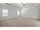 Spacious bedroom with tray ceiling, ceiling fan, and neutral carpet, creating a serene and inviting atmosphere at 3293 Lions Ruby Ln, Atlanta, GA 30349
