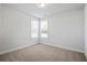 Bedroom with two windows, neutral walls and carpet flooring at 3293 Lions Ruby Ln, Atlanta, GA 30349