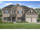 Charming two-story brick home with a well-manicured lawn and two car garage at 3293 Lions Ruby Ln, Atlanta, GA 30349