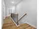 Upstairs hallway with hardwood floors and a staircase at 3293 Lions Ruby Ln, Atlanta, GA 30349