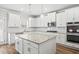 Open kitchen with granite countertops, white cabinets and stainless steel double oven at 3293 Lions Ruby Ln, Atlanta, GA 30349