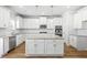 Bright, open kitchen with an island, granite counters, stainless appliances and white cabinetry at 3293 Lions Ruby Ln, Atlanta, GA 30349
