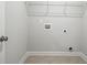 Compact laundry room with tile flooring and convenient shelving at 3293 Lions Ruby Ln, Atlanta, GA 30349
