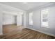 Open living room with beautiful hardwood floors, large windows, and modern trim at 3293 Lions Ruby Ln, Atlanta, GA 30349