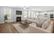 Living room with fireplace, modern sofas, and an open layout with kitchen at 3293 Lions Ruby Ln, Atlanta, GA 30349