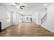 Spacious living room with hardwood floors, leading to a modern kitchen and staircase at 3293 Lions Ruby Ln, Atlanta, GA 30349