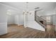 Inviting living room with stylish wood flooring, crown molding, and stairway access at 3293 Lions Ruby Ln, Atlanta, GA 30349