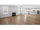 Open floor plan featuring a living room with fireplace and a modern kitchen with stainless appliances at 3293 Lions Ruby Ln, Atlanta, GA 30349