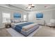 Elegantly furnished bedroom with a tray ceiling, ceiling fan, and two large windows at 3293 Lions Ruby Ln, Atlanta, GA 30349