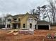 New construction home showing siding, windows, and garage; materials in the yard, and wrap installed at 4085 Sierra Vista Cir, Cumming, GA 30040
