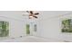 Bright bedroom with a ceiling fan showcasing large windows with backyard views and neutral walls at 475 Nottingham Dr, Marietta, GA 30066