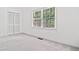 Bright bedroom with neutral carpet and large windows offering ample natural light at 475 Nottingham Dr, Marietta, GA 30066