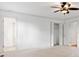 Neutral bedroom with closet and ensuite entry showcasing clean lines and a ceiling fan at 475 Nottingham Dr, Marietta, GA 30066
