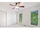 Neutral bedroom featuring a ceiling fan, closet, and backyard views at 475 Nottingham Dr, Marietta, GA 30066