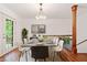 Open dining area with modern lighting, wood floors, and access to the outdoor patio at 475 Nottingham Dr, Marietta, GA 30066
