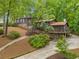 Beautiful exterior showcasing stone accents, wood siding, a deck, and a well-maintained yard at 475 Nottingham Dr, Marietta, GA 30066