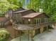 Unique split-level home with expansive deck and lower level garage, surrounded by mature trees at 475 Nottingham Dr, Marietta, GA 30066