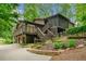 Multi-level home with wooden stairs, deck, landscaping, and brick accents at 475 Nottingham Dr, Marietta, GA 30066