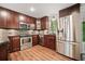Updated kitchen with stainless steel appliances, dark wood cabinets, and granite countertops at 475 Nottingham Dr, Marietta, GA 30066