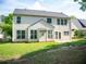 Exterior view of the home backyard featuring a patio and well-maintained lawn at 663 Prada Ct, Lawrenceville, GA 30043