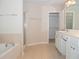 Full bathroom with separate shower and tub, double sink, and walk-in closet at 663 Prada Ct, Lawrenceville, GA 30043