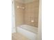 Clean and minimalist full bath with a tub and tile surround at 663 Prada Ct, Lawrenceville, GA 30043