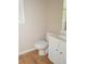 Modest powder room featuring tile flooring and a classic white vanity and toilet at 663 Prada Ct, Lawrenceville, GA 30043