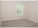 Cozy bedroom with plush carpeting and a window providing natural light at 663 Prada Ct, Lawrenceville, GA 30043