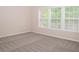 Inviting bedroom with neutral walls, plush carpet, and a bright window at 663 Prada Ct, Lawrenceville, GA 30043
