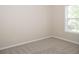 Neutral bedroom with a window, carpet flooring, and cream-colored walls at 663 Prada Ct, Lawrenceville, GA 30043