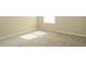 Clean bedroom featuring neutral carpet, white trim, and a window at 663 Prada Ct, Lawrenceville, GA 30043
