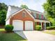 Charming two-story brick home with a two-car garage, inviting front porch and manicured lawn in a residential neighborhood at 663 Prada Ct, Lawrenceville, GA 30043