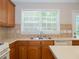 Well-lit kitchen featuring a stainless steel sink and tiled backsplash at 663 Prada Ct, Lawrenceville, GA 30043