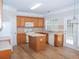 Spacious kitchen with wooden cabinets, white appliances, an island and stylish tile backsplash at 663 Prada Ct, Lawrenceville, GA 30043