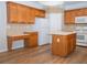 Spacious kitchen with wooden cabinets, white appliances, an island and stylish tile backsplash at 663 Prada Ct, Lawrenceville, GA 30043