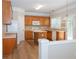 Spacious kitchen with wooden cabinets, white appliances, an island and stylish tile backsplash at 663 Prada Ct, Lawrenceville, GA 30043