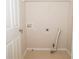 A modest laundry room with tile flooring and hookups for a washer and dryer at 663 Prada Ct, Lawrenceville, GA 30043