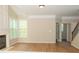 Cozy living room featuring a fireplace and an adjacent hallway and bath at 663 Prada Ct, Lawrenceville, GA 30043