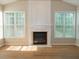 Bright living room features a fireplace and lots of natural light from the windows at 663 Prada Ct, Lawrenceville, GA 30043