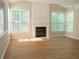 A spacious living room that features a fireplace and lots of natural light at 663 Prada Ct, Lawrenceville, GA 30043