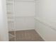 Bright walk-in closet featuring wire shelving and neutral carpeting for optimal storage at 663 Prada Ct, Lawrenceville, GA 30043