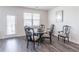 Cozy dining area featuring a table with chairs, a window, and stylish floors at 2010 Vidalia Ct, Dacula, GA 30019