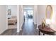 Inviting home hallway featuring stylish flooring, with views into the bedroom, living room, and dining room at 2010 Vidalia Ct, Dacula, GA 30019