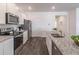 Stylish kitchen with granite countertops, stainless steel appliances, and modern fixtures at 2010 Vidalia Ct, Dacula, GA 30019