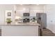 Modern kitchen with granite countertops, stainless steel appliances, and a view to the bedroom at 2010 Vidalia Ct, Dacula, GA 30019