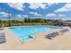 Resort-style swimming pool with lounge chairs, umbrellas, and lush landscaping at 2010 Vidalia Ct, Dacula, GA 30019