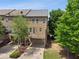 Aerial view of townhomes featuring a balcony and a convenient drive-under garage at 2020 Jardin Ct, Alpharetta, GA 30022