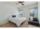 Light-filled bedroom with a ceiling fan, two windows with blinds and an inviting chaise lounge chair at 2020 Jardin Ct, Alpharetta, GA 30022